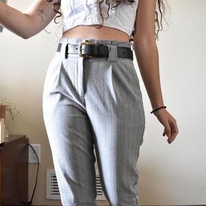 Soft gray pleated slacks with black vertical lines and matching belt